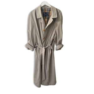 Sand colour belted Burberry trench coat.